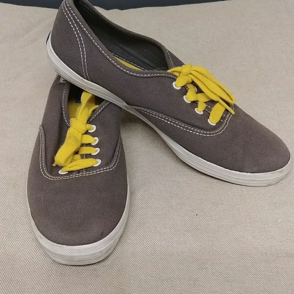 grey keds with yellow laces